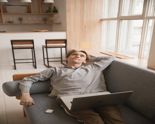 Person relaxing on a sofa with proper back support